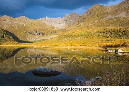 Stock Photo - "Mountains reflected in lake Keilvatnet, in autumn, Eggum, Lofoten, Norway, Europe". Fotosearch