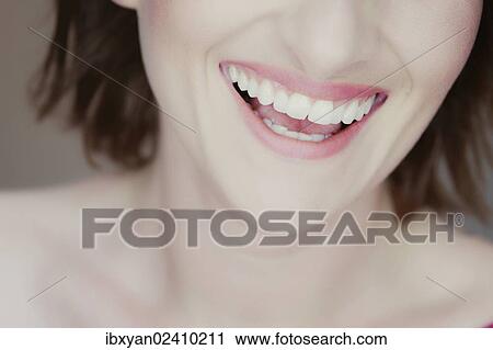 Stock Image - "Mouth of a smiling young woman, detail". Fotosearch