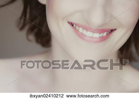 Stock Image - "Mouth of a smiling young woman, detail". Fotosearch