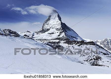 Stock Image - "Mt. Matterhorn with a cloud flag in Zermatt, Valais, Switzerland, Europe". Fotosearch