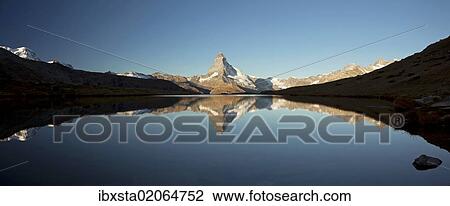 Stock Image - "Mt Matterhorn with reflections in Stellisee Lake in the first morning light, Zermatt, Valais, Switzerland, Europe". Fotosearch