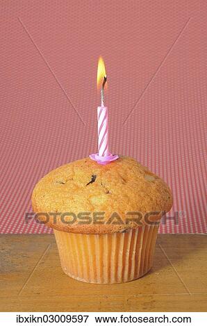 Muffin with a birthday candle View Large Photo Image Stock Photo - Muffin with a birthday candle. Fotosearch