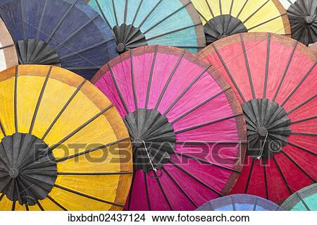 "Multicoloured hand-made paper umbrellas or parasols on display at a market in Luang Prabang, Laos, Southeast Asia, Asia" View Large Photo Image Picture - "Multicoloured hand-made paper umbrellas or parasols on display at a market in Luang Prabang, Laos, Southeast Asia, Asia". Fotosearch