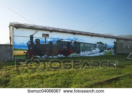 "Mural of an old steam locomotive on a warehouse at Rehna Station, Rehna, Mecklenburg-Western Pomerania, Germany, Europe" View Large Photo Image Stock Photo - "Mural of an old steam locomotive on a warehouse at Rehna Station, Rehna, Mecklenburg-Western Pomerania, Germany, Europe". Fotosearch