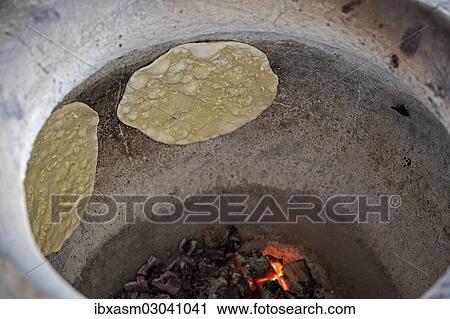 "Naan bread, Indian flat bread baked in a tandoori oven" View Large Photo Image Stock Image - "Naan bread, Indian flat bread baked in a tandoori oven". Fotosearch