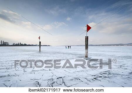 "Navigation mark on a frozen Lake Constance with skaters, island auf Reichenau, Konstanz district, Baden-Wuerttemberg, Germany, Europe" View Large Photo Image Stock Photo - "Navigation mark on a frozen Lake Constance with skaters, island auf Reichenau, Konstanz district, Baden-Wuerttemberg, Germany, Europe". Fotosearch