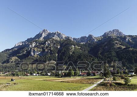 "Nesselwaengle village, Tannheimer Tal high valley, Mt. Gimpel left and Mt. Kellenspitze, Tannheimer Berge mountains, Tyrol, Austria, Europe" View Large Photo Image Stock Photo - "Nesselwaengle village, Tannheimer Tal high valley, Mt. Gimpel left and Mt. Kellenspitze, Tannheimer Berge mountains, Tyrol, Austria, Europe". Fotosearch