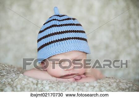 "Newborn baby, 3 weeks, sleeping, wearing a hat" View Large Photo Image Stock Image - "Newborn baby, 3 weeks, sleeping, wearing a hat". Fotosearch