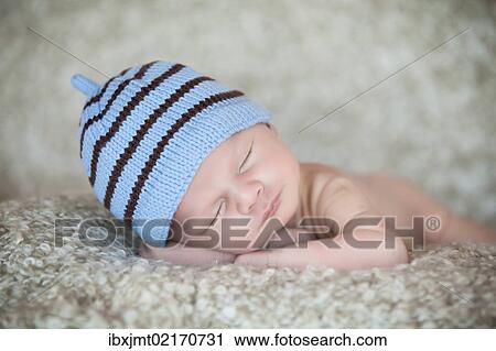 "Newborn baby, 3 weeks, sleeping, wearing a hat" View Large Photo Image Stock Image - "Newborn baby, 3 weeks, sleeping, wearing a hat". Fotosearch