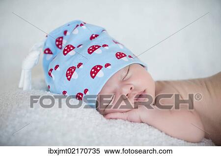"Newborn baby, 3 weeks, sleeping, wearing a hat" View Large Photo Image Stock Photography - "Newborn baby, 3 weeks, sleeping, wearing a hat". Fotosearch