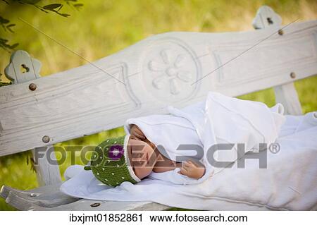 "Newborn baby girl, two weeks old, lying on an outdoors bench" View Large Photo Image Stock Image - "Newborn baby girl, two weeks old, lying on an outdoors bench". Fotosearch