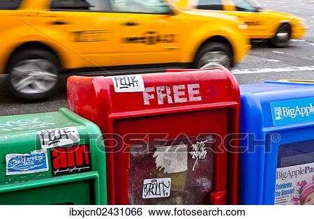 "Newspaper vending machines on the roadside, taxis passing at the back, Soho, New York City, USA" View Large Photo Image Stock Photograph - "Newspaper vending machines on the roadside, taxis passing at the back, Soho, New York City, USA". Fotosearch