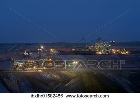 Stock Photograph - "Night shift in an open-pit mine, Grevenbroich, North Rhine-Westphalia, Germany, Europe". Fotosearch