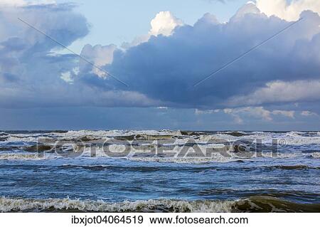 "North Sea beach, stormy sea, dark clouds during an autumn storm, De Haan, Flanders, Belgium, Europe" View Large Photo Image Stock Photo - "North Sea beach, stormy sea, dark clouds during an autumn storm, De Haan, Flanders, Belgium, Europe". Fotosearch