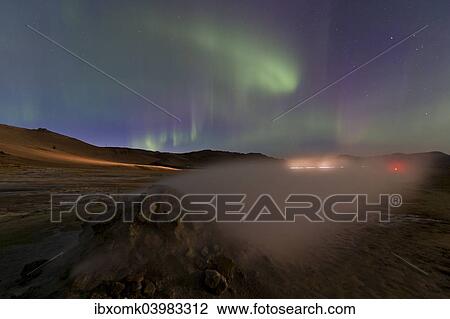 Stock Image - "Northern lights, light trails from cars, solfatara, fumaroles, sulphur and other minerals, steam, Hverarond high temperature or geothermal area, Namafjall mountains, Myvatn area, Northeastern Region, Iceland, Europe". Fotosearch
