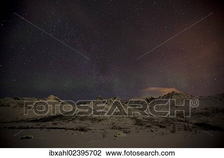 Stock Image - "Northern Lights over the Kattfjord pass in winter, Kvaloya, Tromso, Norway, Europe". Fotosearch