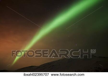 Stock Photo - "Northern Lights over the Kattfjord pass in winter, Kvaloya, Tromso, Norway, Europe". Fotosearch