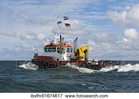 Stock Photo - "Ocean tug boat on the open sea, Germany, Europe". Fotosearch