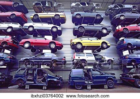 Stock Image - "Old cars at a junkyard, one above the other". Fotosearch