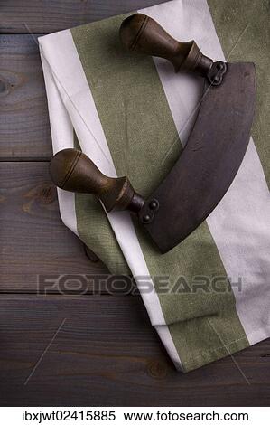 Old chopping knife with a kitchen towel on a wooden background View Large Photo Image Stock Photography - Old chopping knife with a kitchen towel on a wooden background. Fotosearch