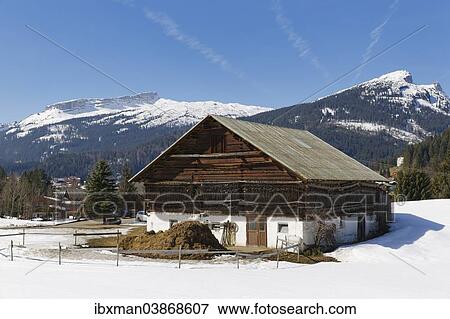 "Old farmhouse in Riezlern, mountains Hoher Ifen and Sonnenberg at the back, Kleinwalsertal valley, Vorarlberg, Austria, Europe" View Large Photo Image Stock Photo - "Old farmhouse in Riezlern, mountains Hoher Ifen and Sonnenberg at the back, Kleinwalsertal valley, Vorarlberg, Austria, Europe". Fotosearch