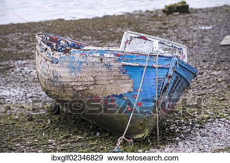 Stock Photo - "Old fishing boat lying on the gravel bed of a river, County Galway, Republic of Ireland, Europe". Fotosearch