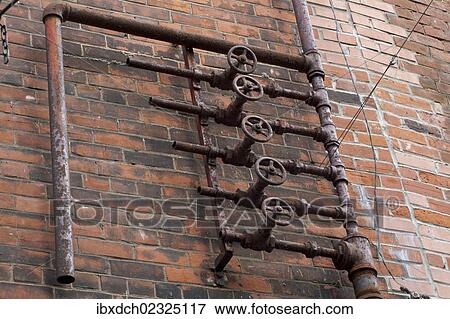 Stock Photo - "Old pipes on brick wall, Montreal, Quebec, Canada, North America". Fotosearch
