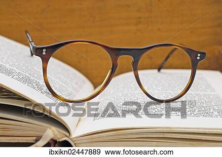 Old reading glasses on a book View Large Photo Image Stock Photo - Old reading glasses on a book. Fotosearch
