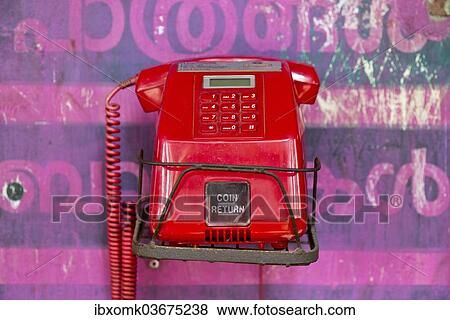 "Old red telephone against a wall with pink Malayalam script, Kerala, India, Asia" View Large Photo Image Stock Photo - "Old red telephone against a wall with pink Malayalam script, Kerala, India, Asia". Fotosearch