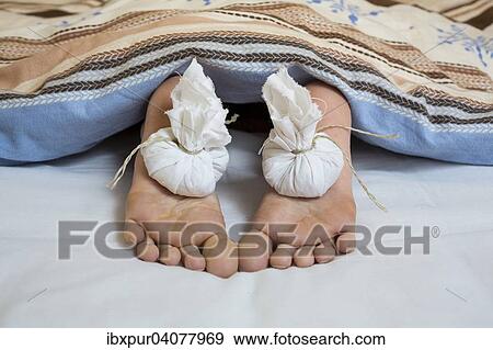 "Onion bags on feet, looking out from under a blanket" View Large Photo Image Stock Photo - "Onion bags on feet, looking out from under a blanket". Fotosearch
