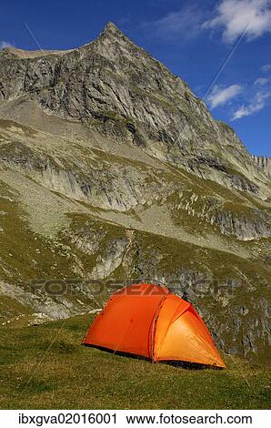 "Orange-coloured mountain tent below the summit of Wiwanni Mountain in the Pennine Alps, Valais, Switzerland, Europe" View Large Photo Image Stock Image - "Orange-coloured mountain tent below the summit of Wiwanni Mountain in the Pennine Alps, Valais, Switzerland, Europe". Fotosearch