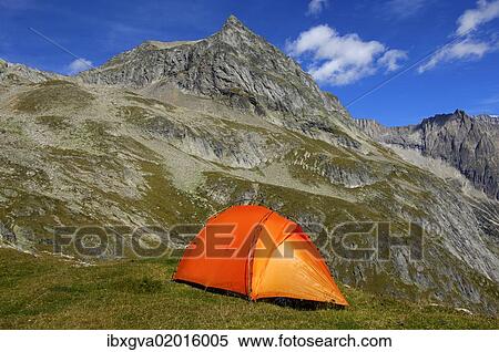 "Orange-coloured mountain tent below the summit of Wiwanni Mountain in the Pennine Alps, Valais, Switzerland, Europe" View Large Photo Image Stock Photography - "Orange-coloured mountain tent below the summit of Wiwanni Mountain in the Pennine Alps, Valais, Switzerland, Europe". Fotosearch