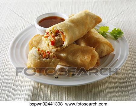 Oriental spring rolls filled with chicken and vegetables with a chilli dipping sauce View Large Photo Image Stock Photo - Oriental spring rolls filled with chicken and vegetables with a chilli dipping sauce. Fotosearch