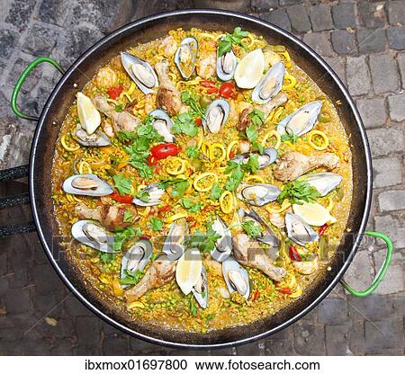 Stock Image - "Paella, a Spanish rice dish with seafood and chicken, series, no. 7". Fotosearch