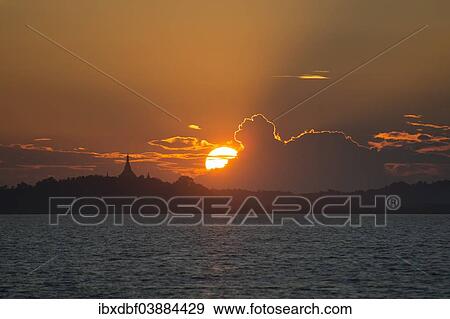 Stock Photo - "Pagoda, sunset behind clouds, Kaladan River, Sittwe District, Rakhine State, Myanmar, Asia". Fotosearch