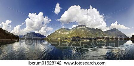 "Panorama of Lake Achensee with the Rofan Mountains and bizarre clouds in the sky reflecting in the lake, Achensee, Tyrol, Austria, Europe" View Large Photo Image Stock Image - "Panorama of Lake Achensee with the Rofan Mountains and bizarre clouds in the sky reflecting in the lake, Achensee, Tyrol, Austria, Europe". Fotosearch