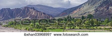 "Panoramic, lush vegetation at the Purmamarca river, behind Cerro de los Siete Colores or Hill of Seven Colors in Purmamarca, Jujuy Province, Argentina, South America" View Large Photo Image Stock Photo - "Panoramic, lush vegetation at the Purmamarca river, behind Cerro de los Siete Colores or Hill of Seven Colors in Purmamarca, Jujuy Province, Argentina, South America". Fotosearch