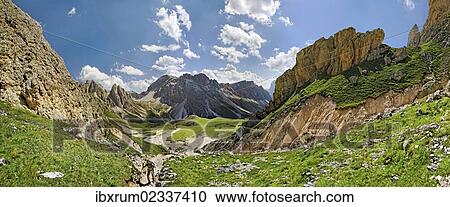 "Panoramic view of the Geisler Mountains, two hikers ascend to Mittagsscharte gorge, Puez-Geisler Nature Park, province of Bolzano-Bozen, Italy, Europe" View Large Photo Image Stock Image - "Panoramic view of the Geisler Mountains, two hikers ascend to Mittagsscharte gorge, Puez-Geisler Nature Park, province of Bolzano-Bozen, Italy, Europe". Fotosearch