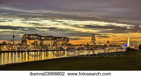 "Panoramic view of the Rhine with Cologne Cathedral, Severinsbrucke Bridge, the Crane Houses, Great St. Martin Church and Colonius telecommunications tower, at dusk, Cologne, North Rhine-Westphalia, Germany, Europe" View Large Photo Image Stock Image - "Panoramic view of the Rhine with Cologne Cathedral, Severinsbrucke Bridge, the Crane Houses, Great St. Martin Church and Colonius telecommunications tower, at dusk, Cologne, North Rhine-Westphalia, Germany, Europe". Fotosearch