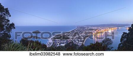 "Panoramic view of the town of Mount Maunganui and the Port of Tauranga at nightfall, from the summit of Mount Maunganui, Bay of Plenty, North Island, New Zealand, Oceania" View Large Photo Image Stock Photo - "Panoramic view of the town of Mount Maunganui and the Port of Tauranga at nightfall, from the summit of Mount Maunganui, Bay of Plenty, North Island, New Zealand, Oceania". Fotosearch