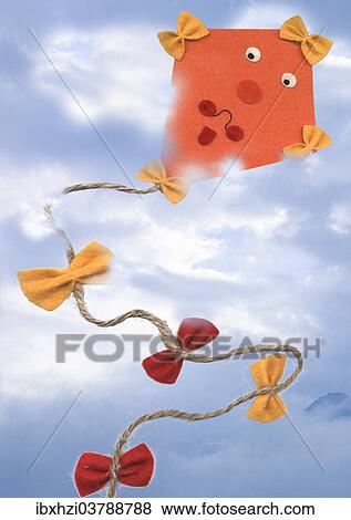 Stock Photo - Paper kite flying in the sky. Fotosearch