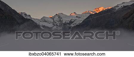 "Paradiso group at sunrise, alpenglow, with fog in valley, Gran Paradiso National Park, Valle di Cogne, Piedmont, Italy, Europe" View Large Photo Image Stock Image - "Paradiso group at sunrise, alpenglow, with fog in valley, Gran Paradiso National Park, Valle di Cogne, Piedmont, Italy, Europe". Fotosearch