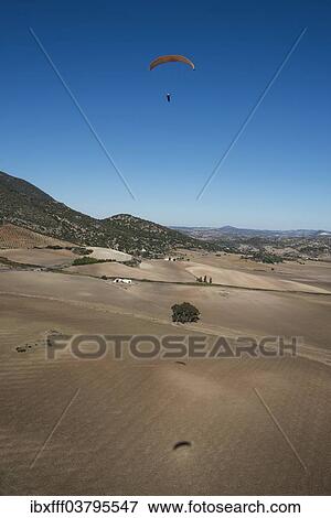 "Paraglider above fields in the Sierra de Cadiz, Andalusia, Spain, Europe" View Large Photo Image Stock Photo - "Paraglider above fields in the Sierra de Cadiz, Andalusia, Spain, Europe". Fotosearch