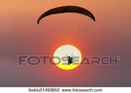 "Paraglider in front of sun, sunset" View Large Photo Image Stock Image - "Paraglider in front of sun, sunset". Fotosearch