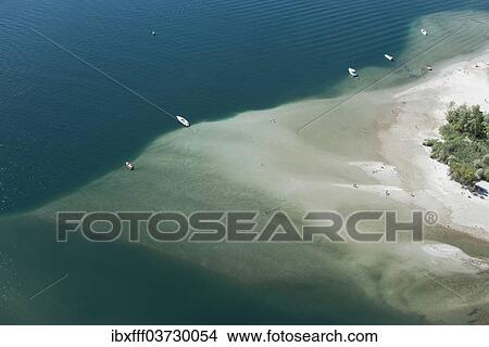 "Paraglider over the Maggia river delta with naturally formed water and rocks terrain, Locarno, Kanton Tessin, Switzerland, Europe" View Large Photo Image Picture - "Paraglider over the Maggia river delta with naturally formed water and rocks terrain, Locarno, Kanton Tessin, Switzerland, Europe". Fotosearch