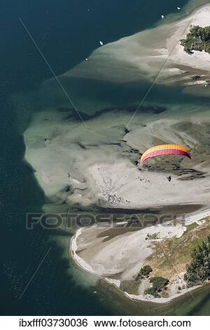 "Paraglider over the Maggia river delta with naturally formed water and rocks terrain, Locarno, Kanton Tessin, Switzerland, Europe" View Large Photo Image Stock Photograph - "Paraglider over the Maggia river delta with naturally formed water and rocks terrain, Locarno, Kanton Tessin, Switzerland, Europe". Fotosearch