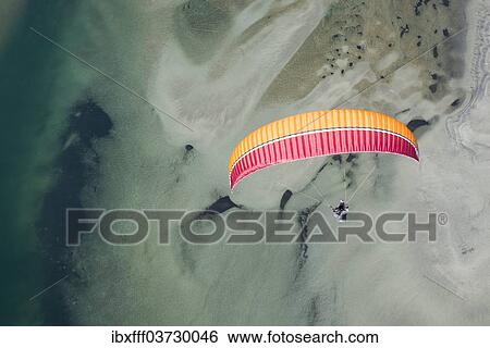 "Paraglider over the Maggia river delta with naturally formed water and rocks terrain, Locarno, Kanton Tessin, Switzerland, Europe" View Large Photo Image Stock Photograph - "Paraglider over the Maggia river delta with naturally formed water and rocks terrain, Locarno, Kanton Tessin, Switzerland, Europe". Fotosearch