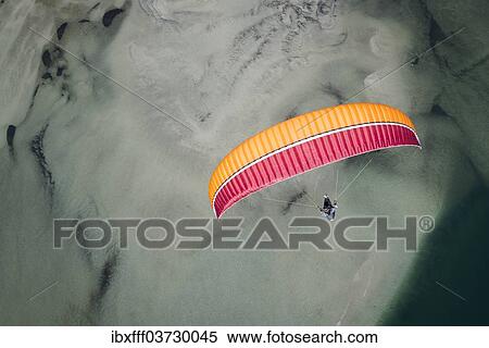 "Paraglider over the Maggia river delta with naturally formed water and rocks terrain, Locarno, Kanton Tessin, Switzerland, Europe" View Large Photo Image Stock Photography - "Paraglider over the Maggia river delta with naturally formed water and rocks terrain, Locarno, Kanton Tessin, Switzerland, Europe". Fotosearch