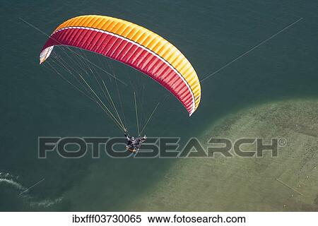 "Paraglider over the Maggia river delta with naturally formed water and rocks terrain, Locarno, Kanton Tessin, Switzerland, Europe" View Large Photo Image Stock Photography - "Paraglider over the Maggia river delta with naturally formed water and rocks terrain, Locarno, Kanton Tessin, Switzerland, Europe". Fotosearch