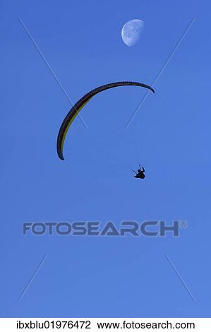 Paraglider with moon View Large Photo Image Stock Image - Paraglider with moon. Fotosearch
